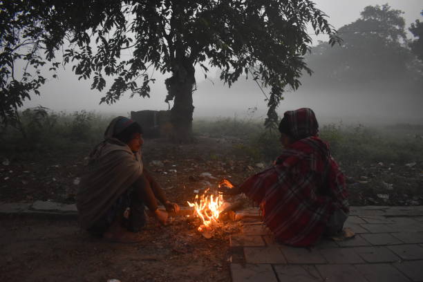 peoples are warm himself by fire on the winter cold morning in kolkata, india.