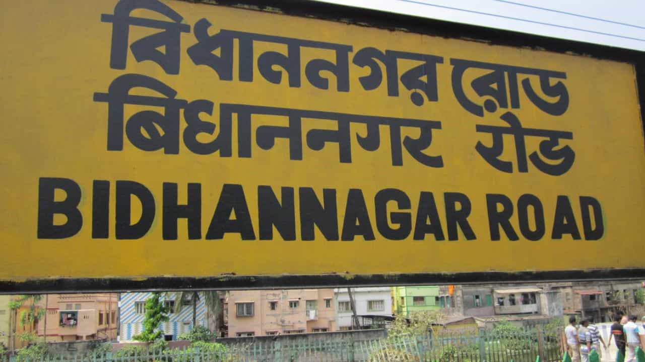 Why are Indian Railways station names written in black on yellow